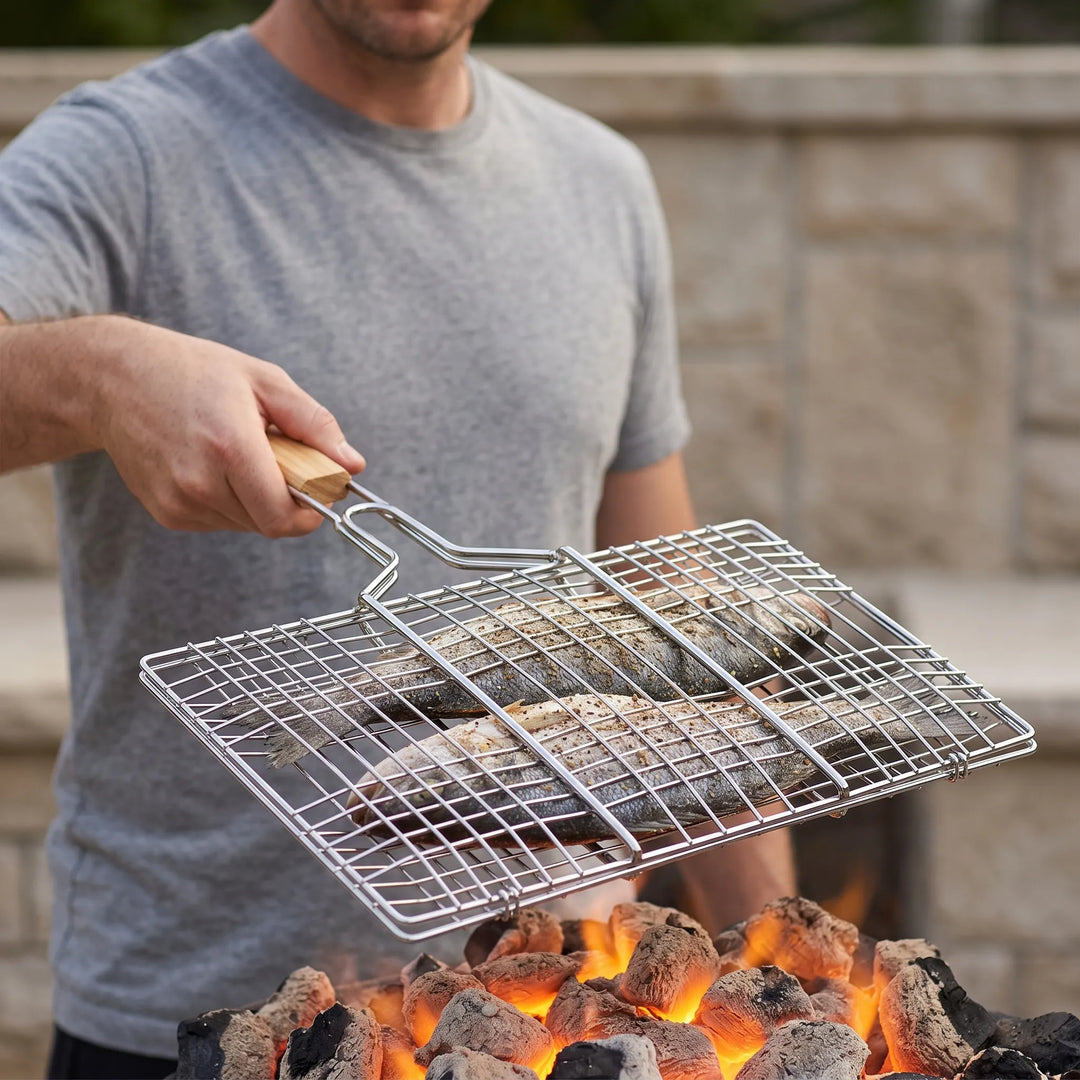Hinged outdoor grilling basket for easy flipping of vegetables, fish, or meats on BBQ or campfire.