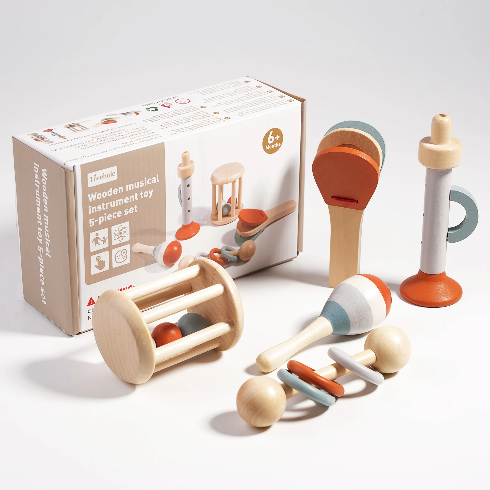 Infant exploring Soft Sounds wooden bells, a Montessori musical toy designed for early learning