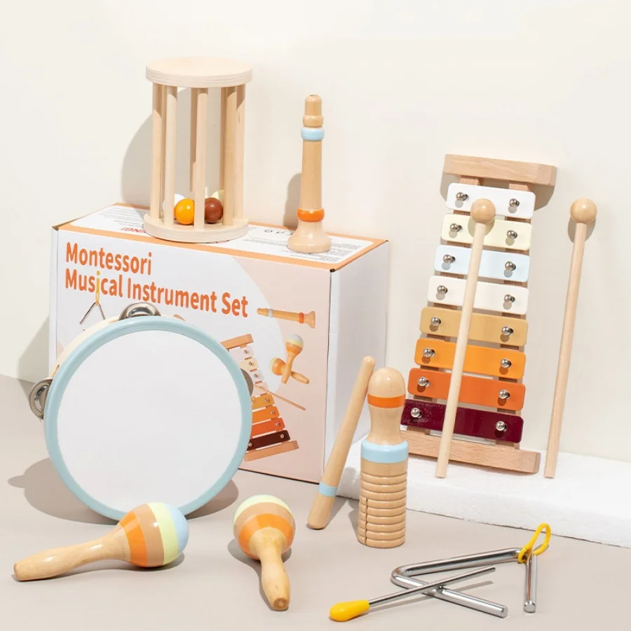 Hand holding an Infant Bell Soft Sounds musical rattle, showcasing a Montessori wooden baby toy