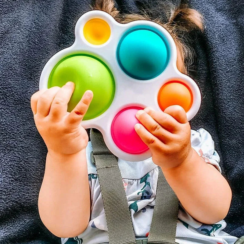 White developmental play board, ideal for toddlers to practice problem-solving and dexterity