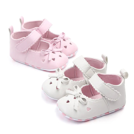 Infant girl's pink soft sole first walker shoes with cute bows, perfect for tiny feet
