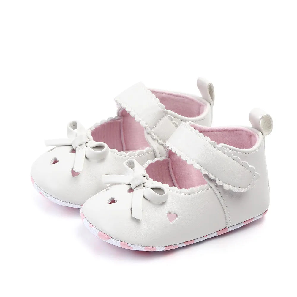 Two pairs of baby girl bow shoes, one pink and one white, soft sole for newborns