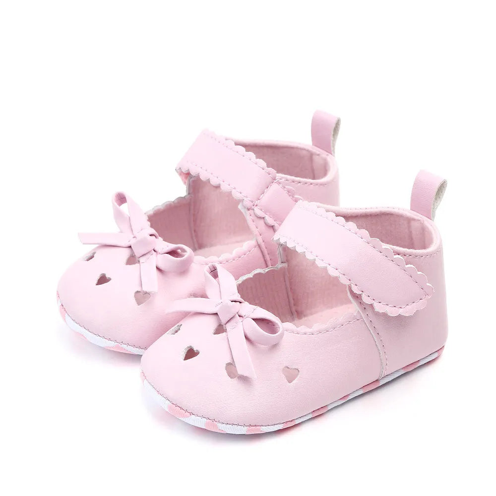 Infant girl's soft sole shoes, first walkers, with sweet bow accents for baby's comfort