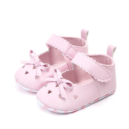 Infant girl's soft sole shoes, first walkers, with sweet bow accents for baby's comfort