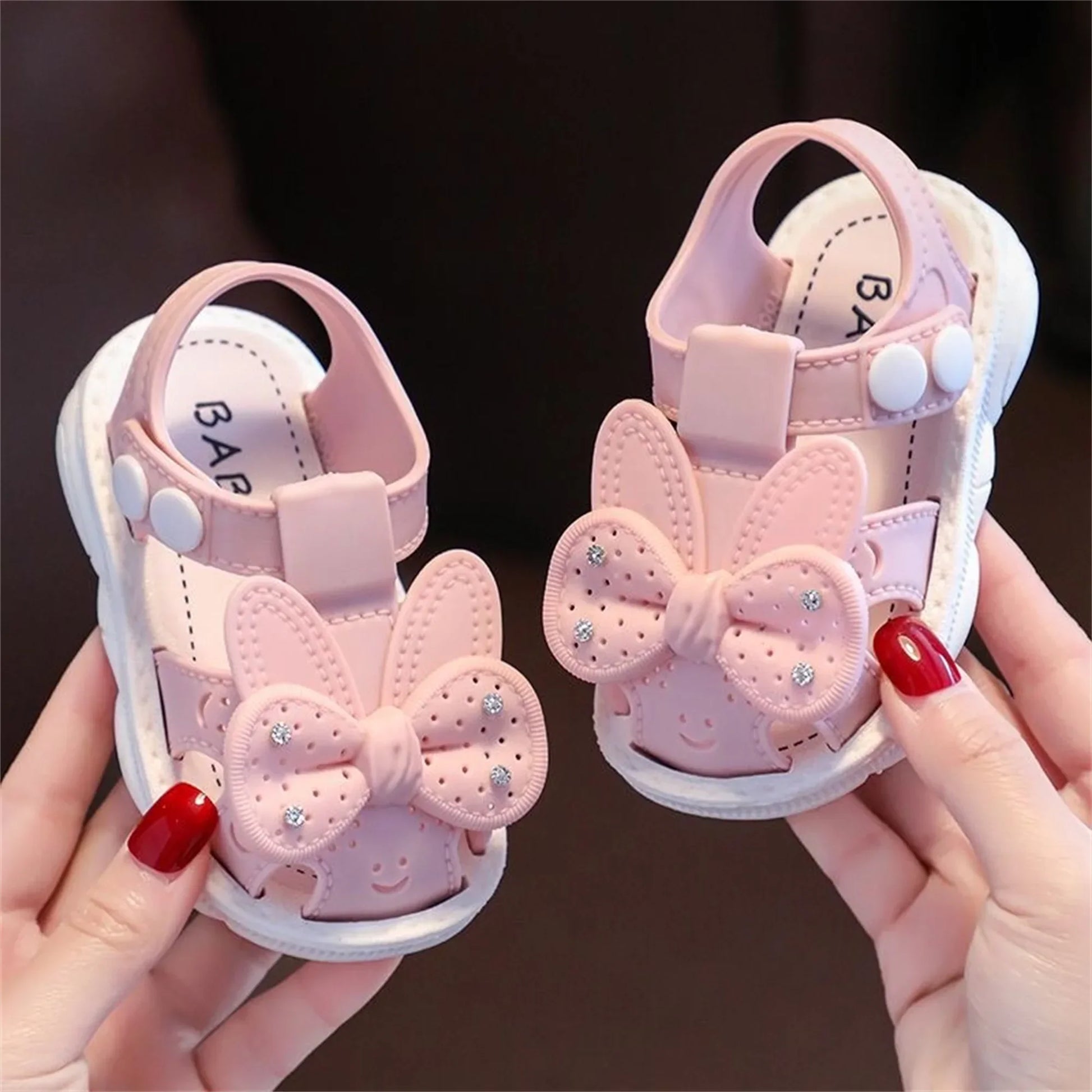 Sweet infant girls' bow sandals in light pink, suitable for warm season play