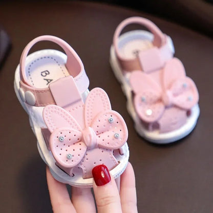 Pair of infant girls' fashion sandals with large bows, perfect for summer