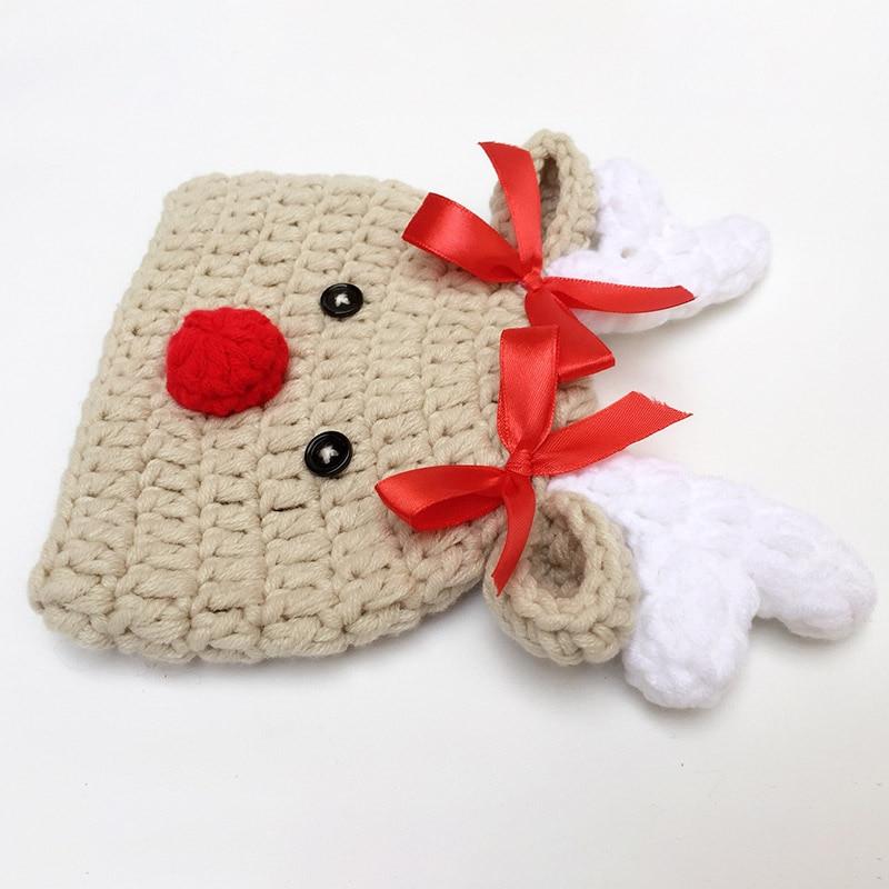 Warm unisex infant Christmas beanie with cute reindeer design. Soft wool holiday cap for babies.