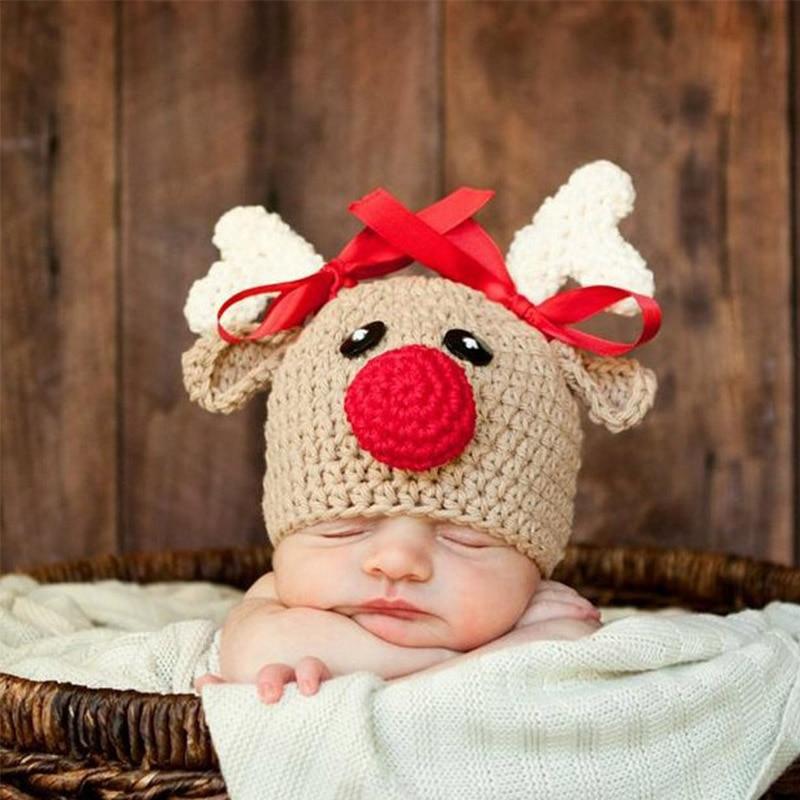 Cozy infant's red & gray reindeer beanie cap. Soft knit wool hat for baby boys & girls' winter comfort.