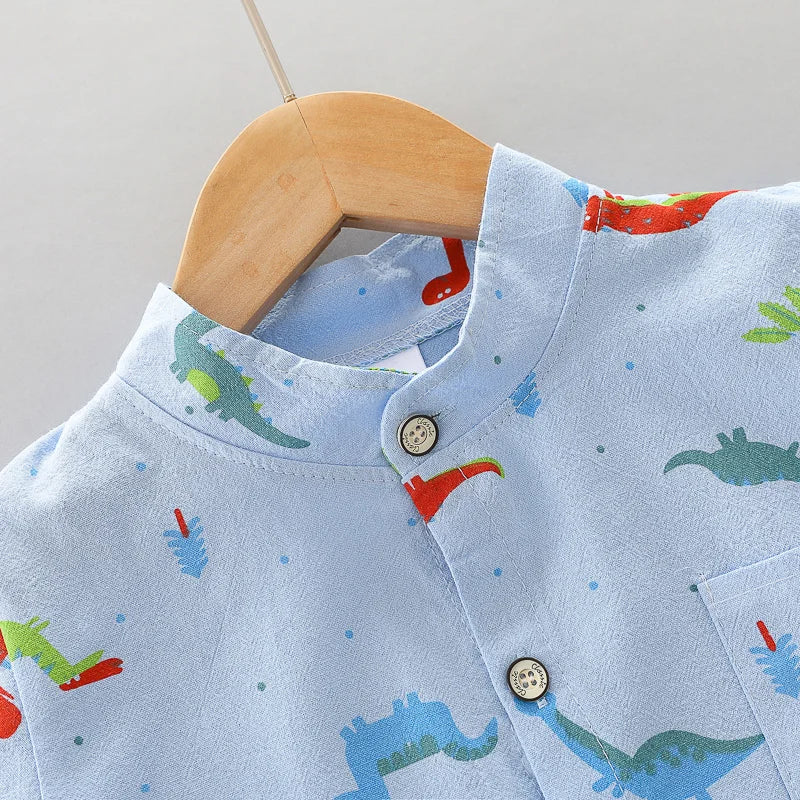 Baby boy wearing a vibrant dinosaur print short sleeve outfit set. Comfortable 2-piece infant clothing.