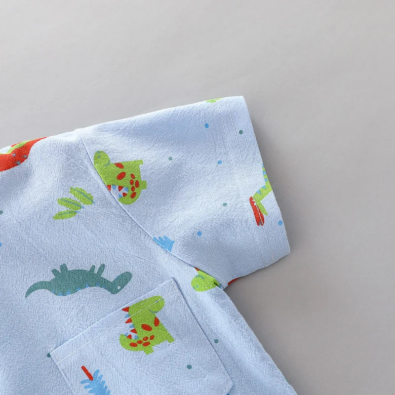 Stylish baby girl in a dinosaur print short sleeve top and matching shorts. Perfect summer toddler outfit.