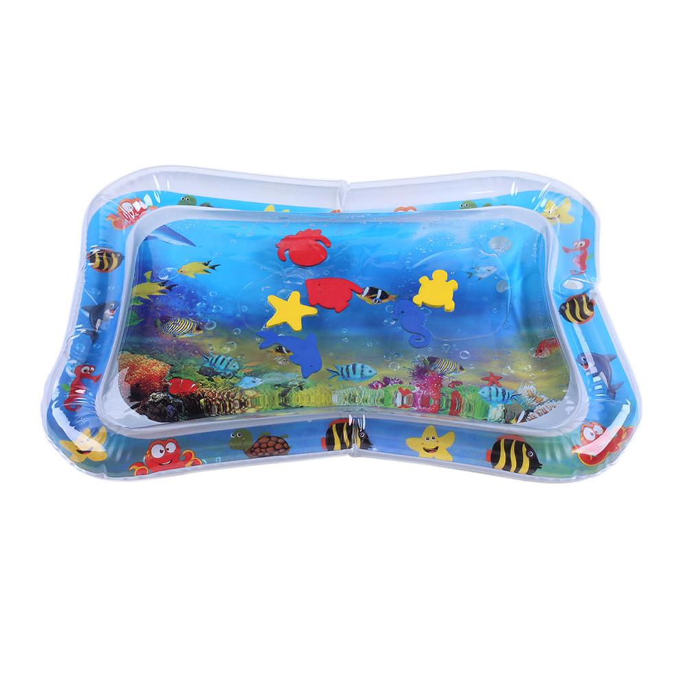 Baby playing on an inflatable water mat, promoting tummy time and motor skills with vibrant undersea graphics.