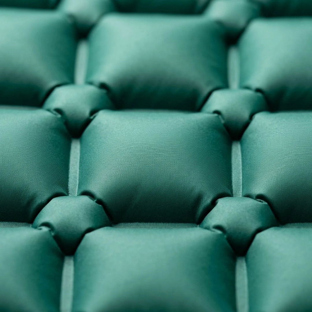 Comfortable outdoor sleeping pad, perfect for camping & hiking. Features an integrated pump for convenience.