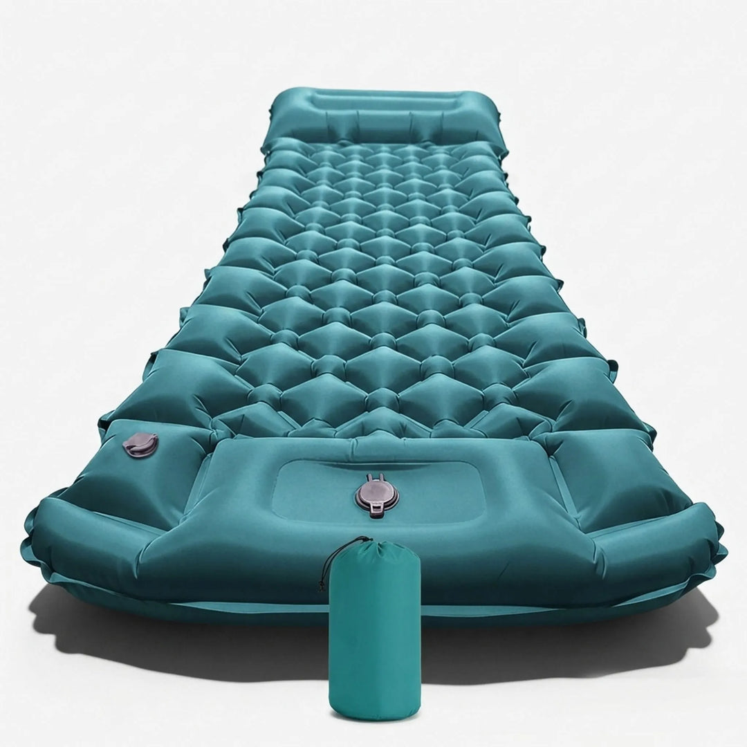 Person inflating a portable camping sleeping mat using its built-in pump for quick outdoor setup.