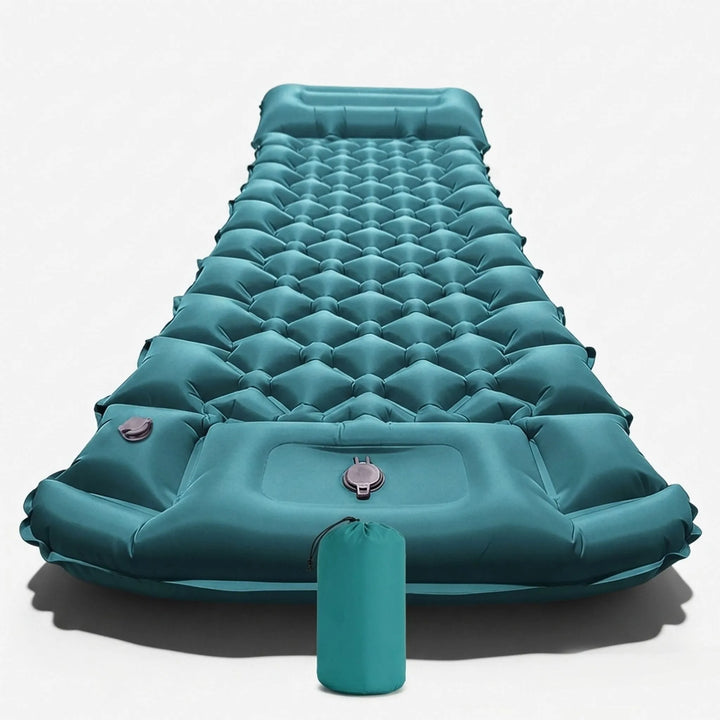 Person inflating a portable camping sleeping mat using its built-in pump for quick outdoor setup.