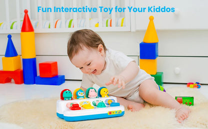 Happy baby discovering sounds from an interactive button toy, early skill building