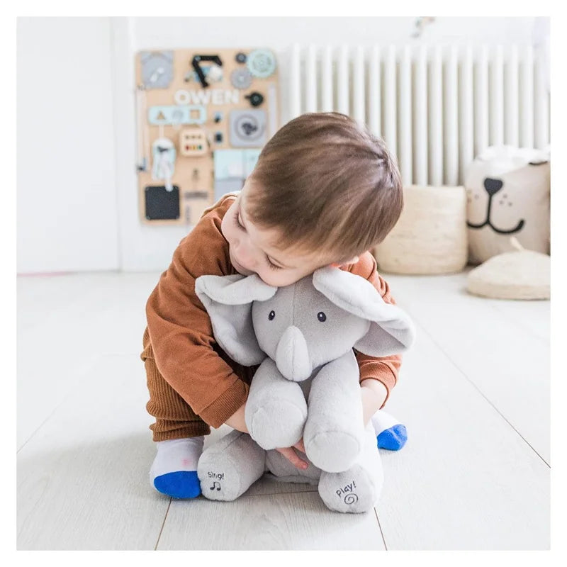Interactive musical elephant plush toy for kids, soft gray comfort toy with sound button.
