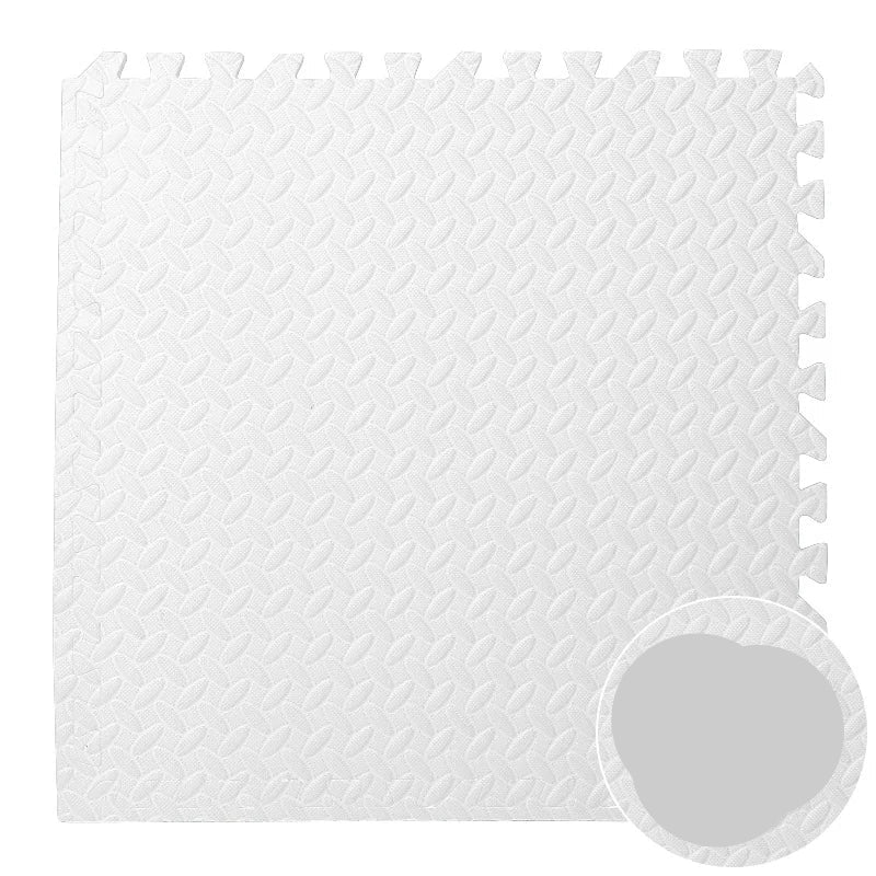 High-angle view of an interlocking foam puzzle play mat in a modern nursery setting