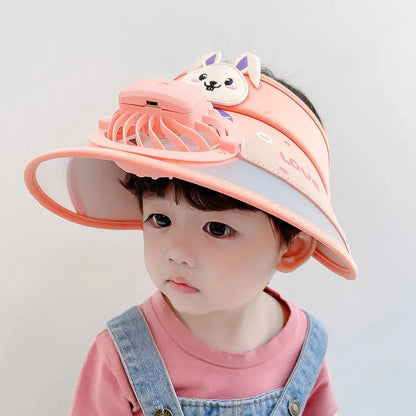 Toddler in a pink cooling fan hat, enjoying sun protection during outdoor play
