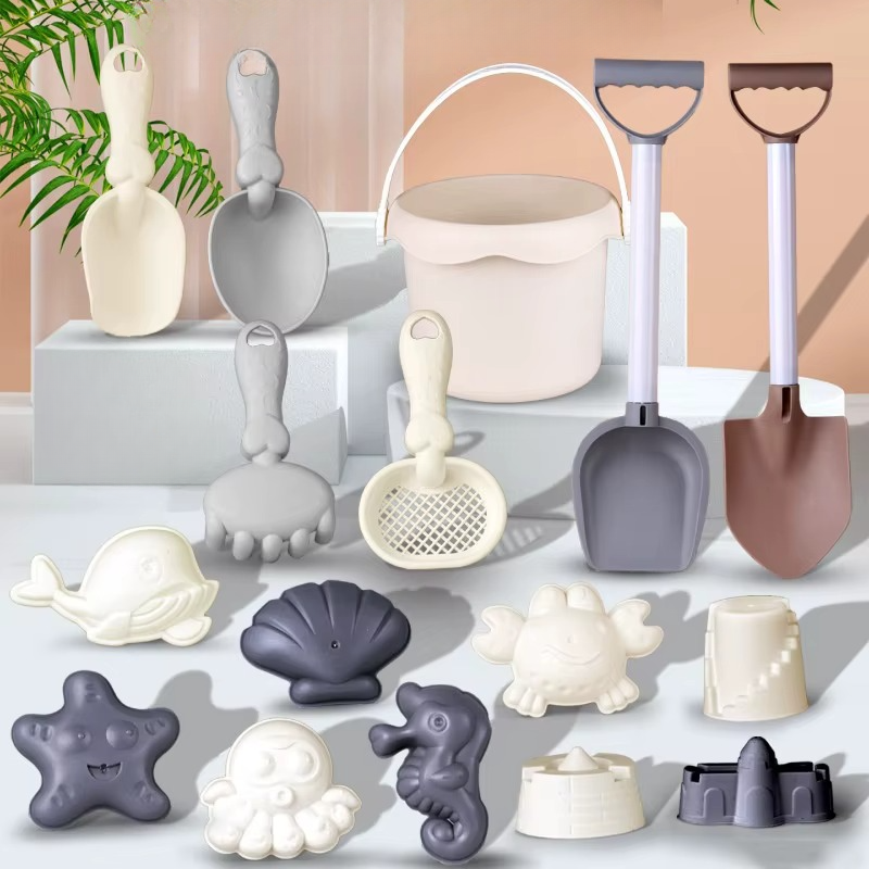 Assorted kids' sand & beach toys, including a hand rake, trowel, and different animal molds.