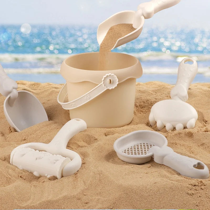 Durable kids' beach toy set with bucket, spade, rakes, and sea animal molds for sand play.