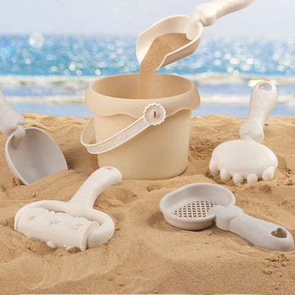 Durable kids' beach toy set with bucket, spade, rakes, and sea animal molds for sand play.