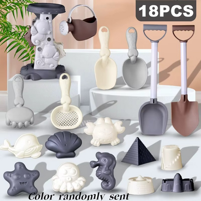 Close-up of kids' beach toy set pieces: colorful shovel, rake, and star-shaped sand mold.