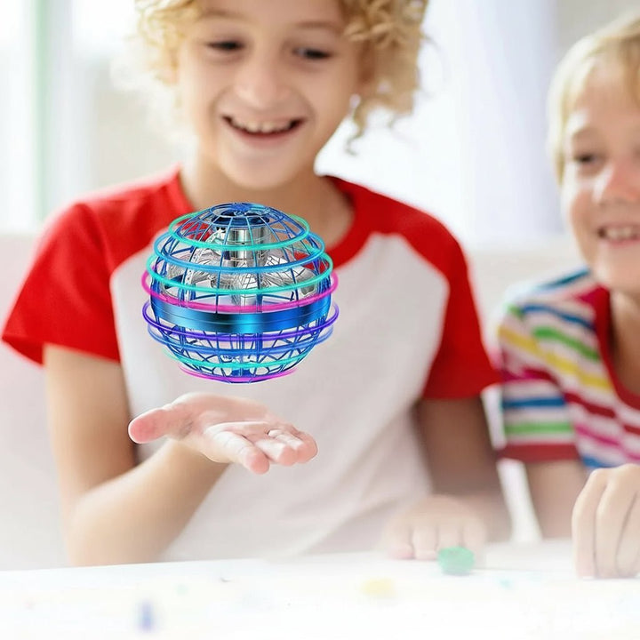Brightly lit kids' flying orb in motion, showcasing its dazzling LED lights and acrobatic flight.