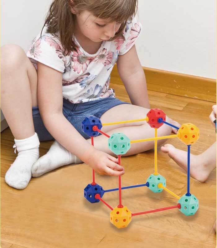 Child building a unique structure with creative geometric blocks, ideal for early learning