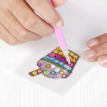 Child's hands working on a diamond painting kit, adding gems to a vibrant unicorn image with frame.