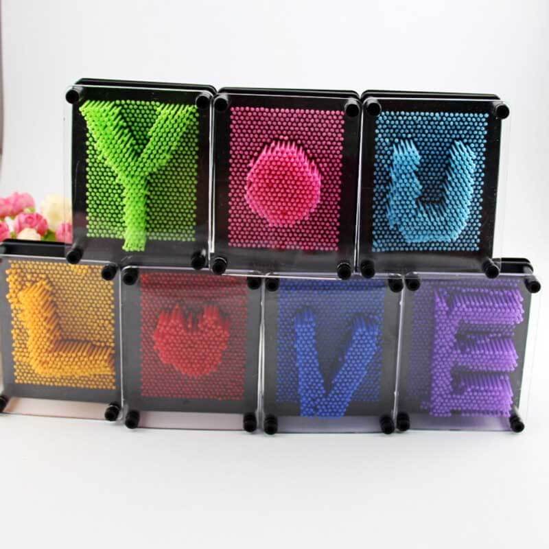 Child molding a hand impression on a colorful 3D Pin Art Board, fostering imagination and sensory play.