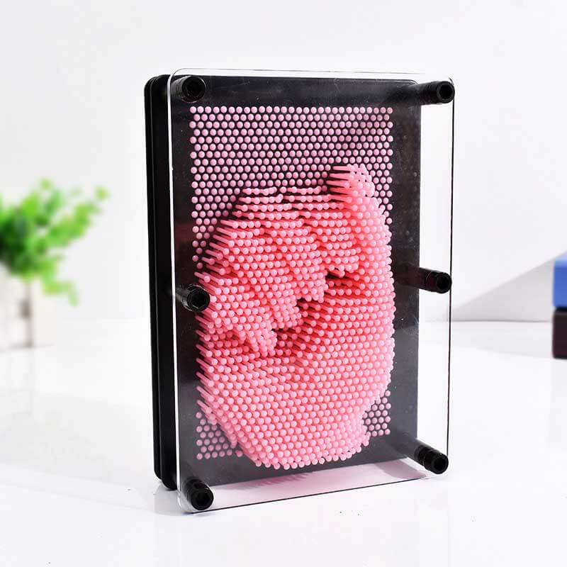A child's face pressed into a clear 3D Pin Art Board, demonstrating interactive and fun diy art.