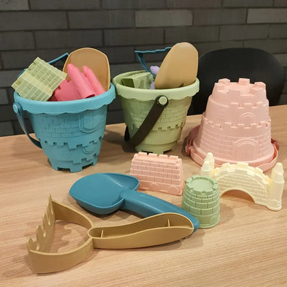 Kids 6-piece beach sand toy set with pink bucket and various colorful molds for summer fun