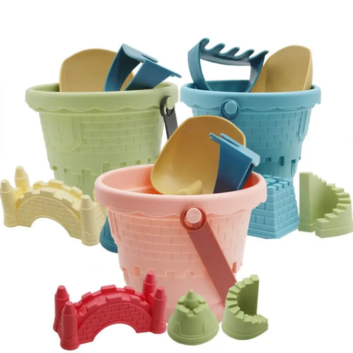Pink bucket from a 6-piece kids beach sand toy set, ideal for collecting shells and water