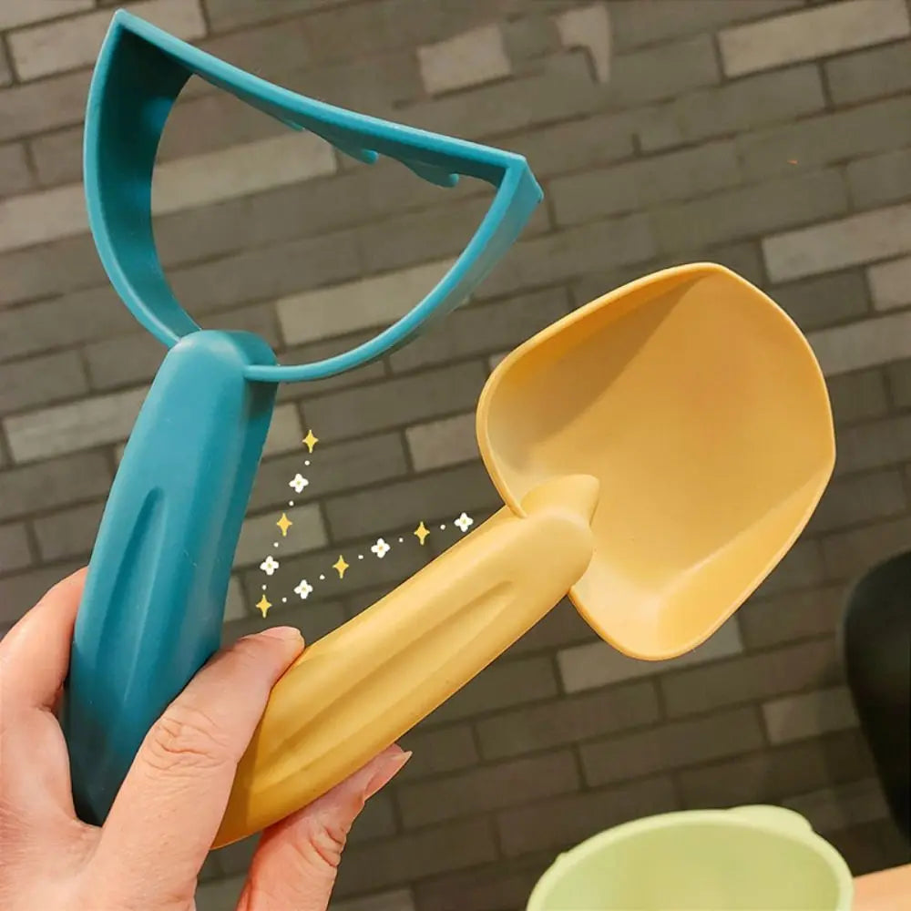 Blue shovel from a kids' beach sand toy set, designed for digging and scooping sand