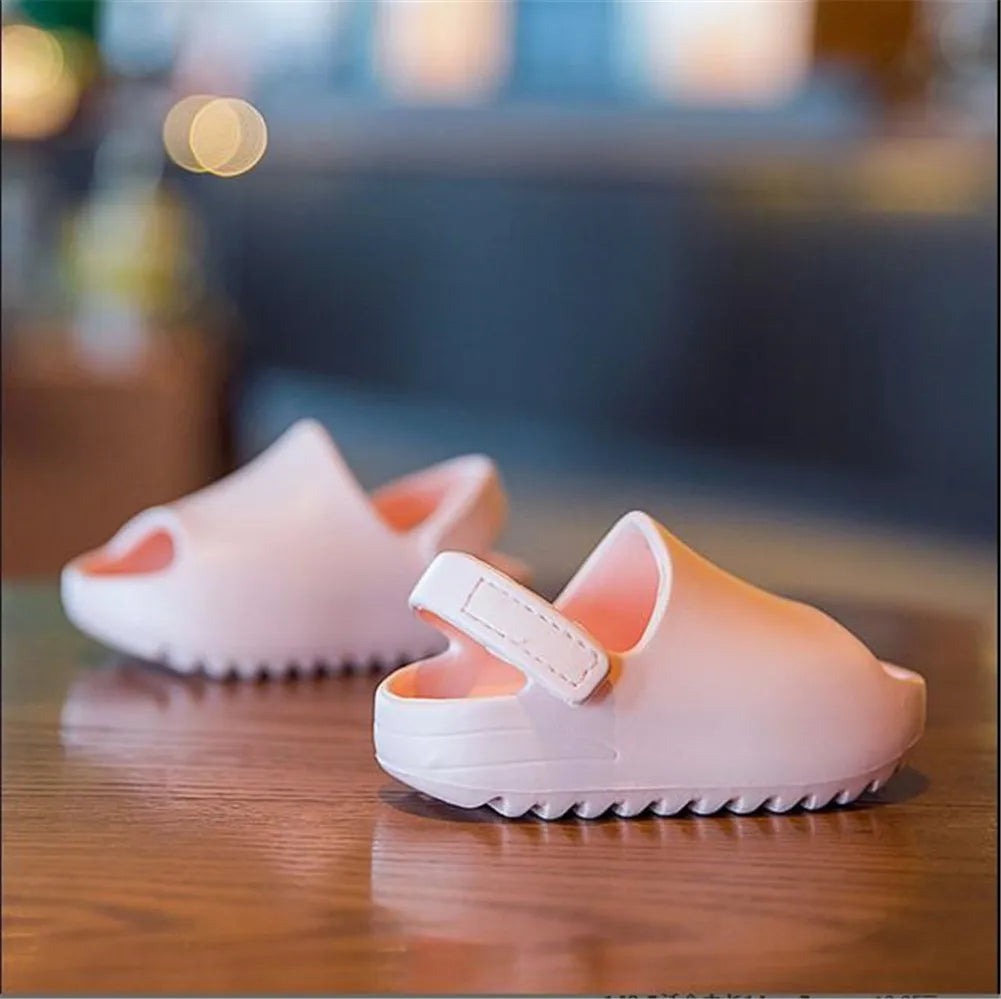 Side view of kids adjustable purple summer sandals, showing flexible design and secure velcro.