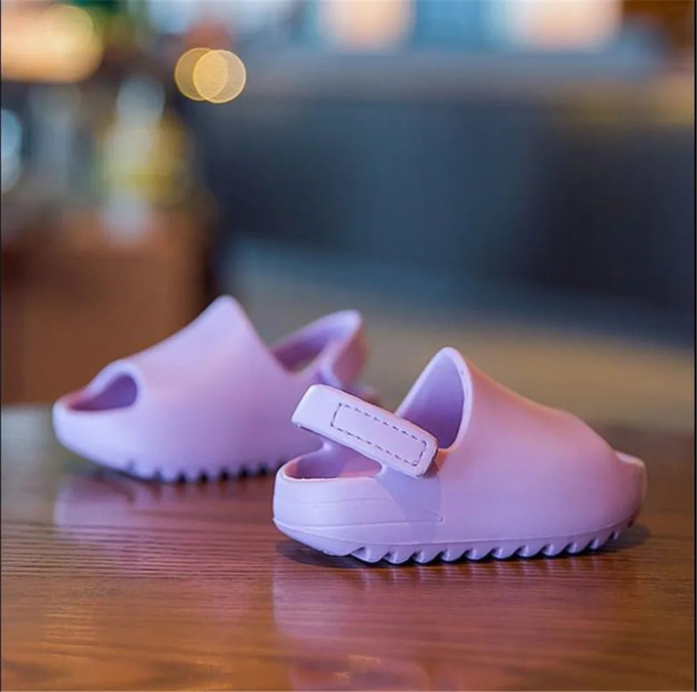 Several pairs of colorful kids adjustable summer sandals arranged, suitable for boys & girls.