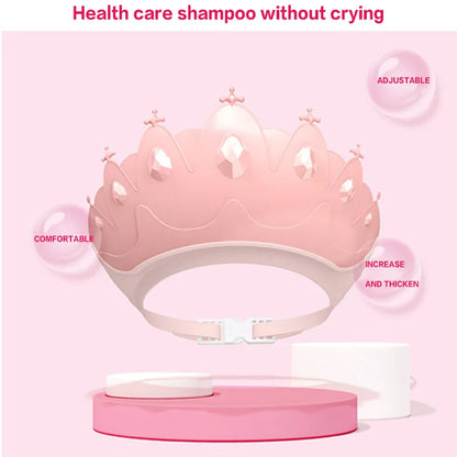 Front view of adjustable kids shower cap, blue with a prominent and playful cartoon crown design.