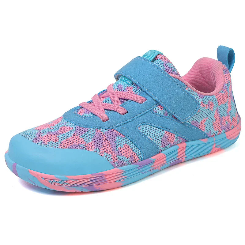 Kids' barefoot non-slip velcro sneakers placed on an outdoor surface, ready for play