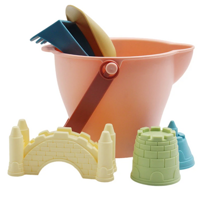Durable kids beach sand toys kit in a mesh bag, featuring a bucket, shovels, and molds for imaginative play.