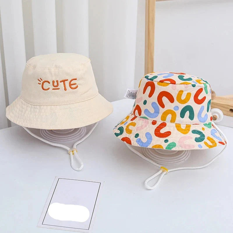 Double-sided beige bucket hat for kids with sun protection, suitable for baby accessories.