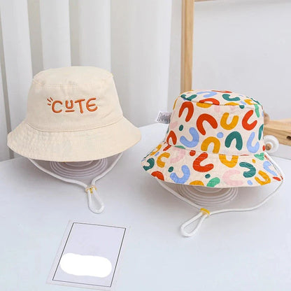 Double-sided beige bucket hat for kids with sun protection, suitable for baby accessories.