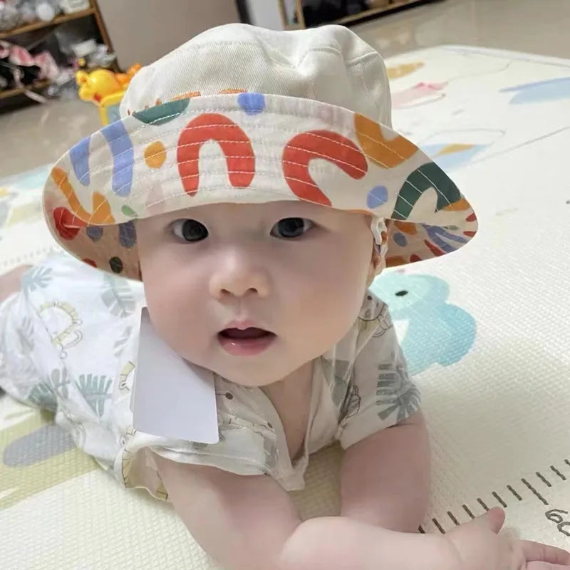 Childrens' beige cotton reversible hat, ideal for sun protection and baby accessories.