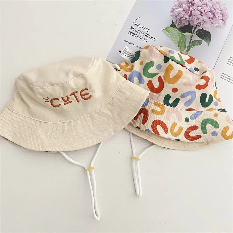 Play-ready beige bucket hat for kids, reversible design offering maximum sun protection.