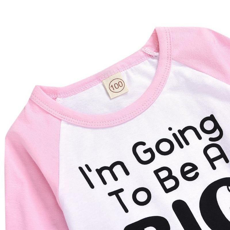 Soft cotton kids t-shirt with 'I'm a Big Sister' text, great for pregnancy reveal photoshoots.