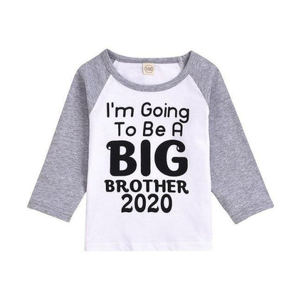 Close-up of a 'Big Sister' t-shirt graphic, detailing the joyful pregnancy announcement design.