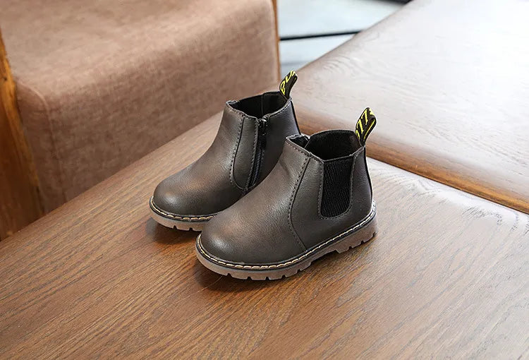 Black leather children's footwear, zippered winter boots offering comfort and warmth