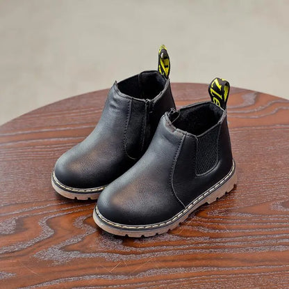 Pair of children's black winter boots, zippered design, ready for snow and outdoor play