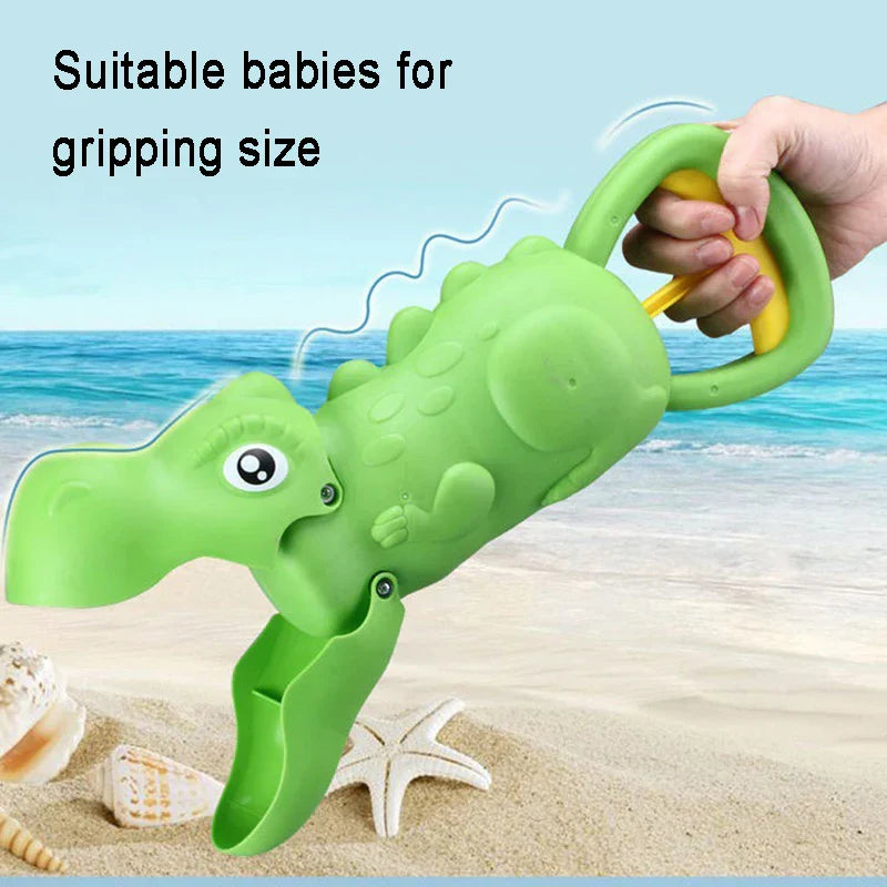 Red sand claw toy shaped like a dinosaur, ideal for creative kids' beach play