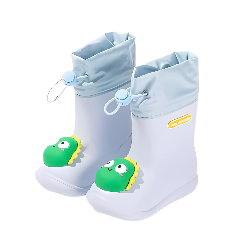 Child jumping in a puddle wearing blue dinosaur waterproof rain boots