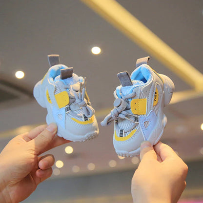 Side view of kids' grey mesh sports shoes, lightweight & flexible